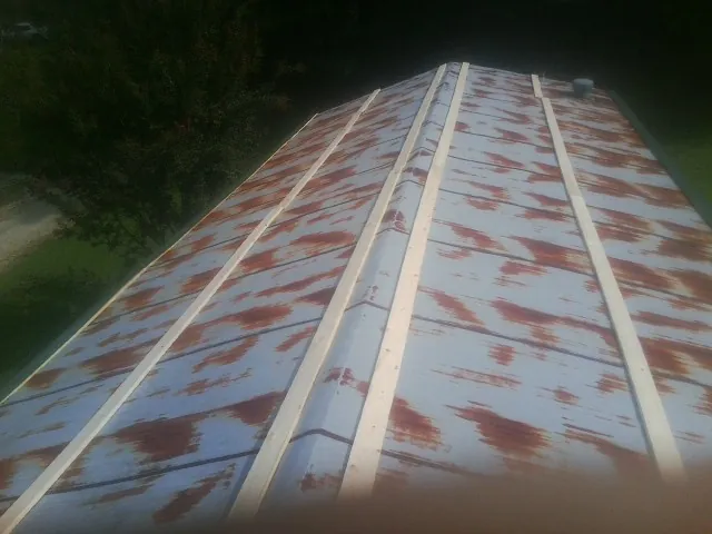 Rusted metal roof panels with new wood purlins before replacement — Storm Damage Roof Repair in Fallsburg by Roofing Brothers