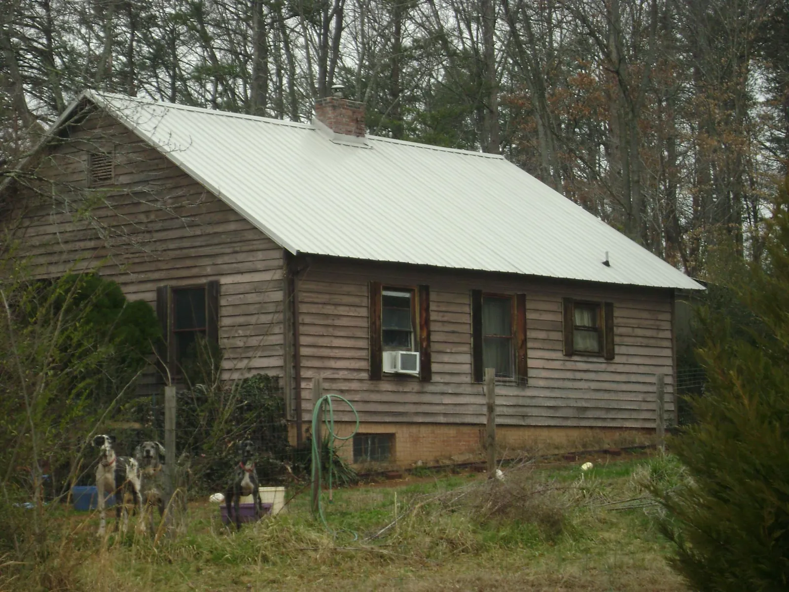 White metal roof on an old wood sided farmhouse, from a Metal Roof Installation job in Fallsburg
